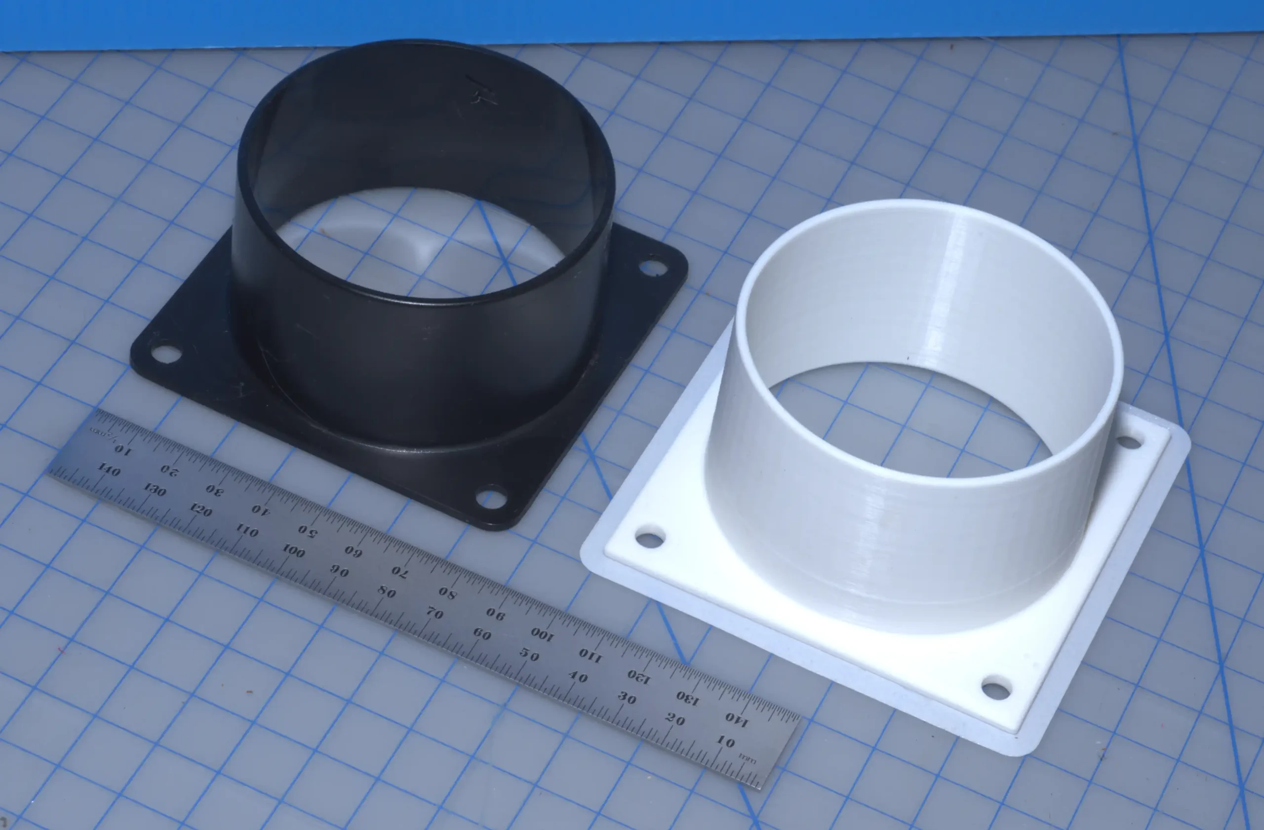 two exhaust flanges, one purchased, the other a 3D printer copy